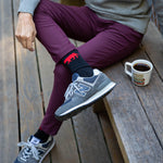 Showing off the red and black Equator performance socks outdoors with a pair of New Balance | Equator Coffees
