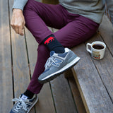 Showing off the red and black Equator performance socks outdoors with a pair of New Balance | Equator Coffees