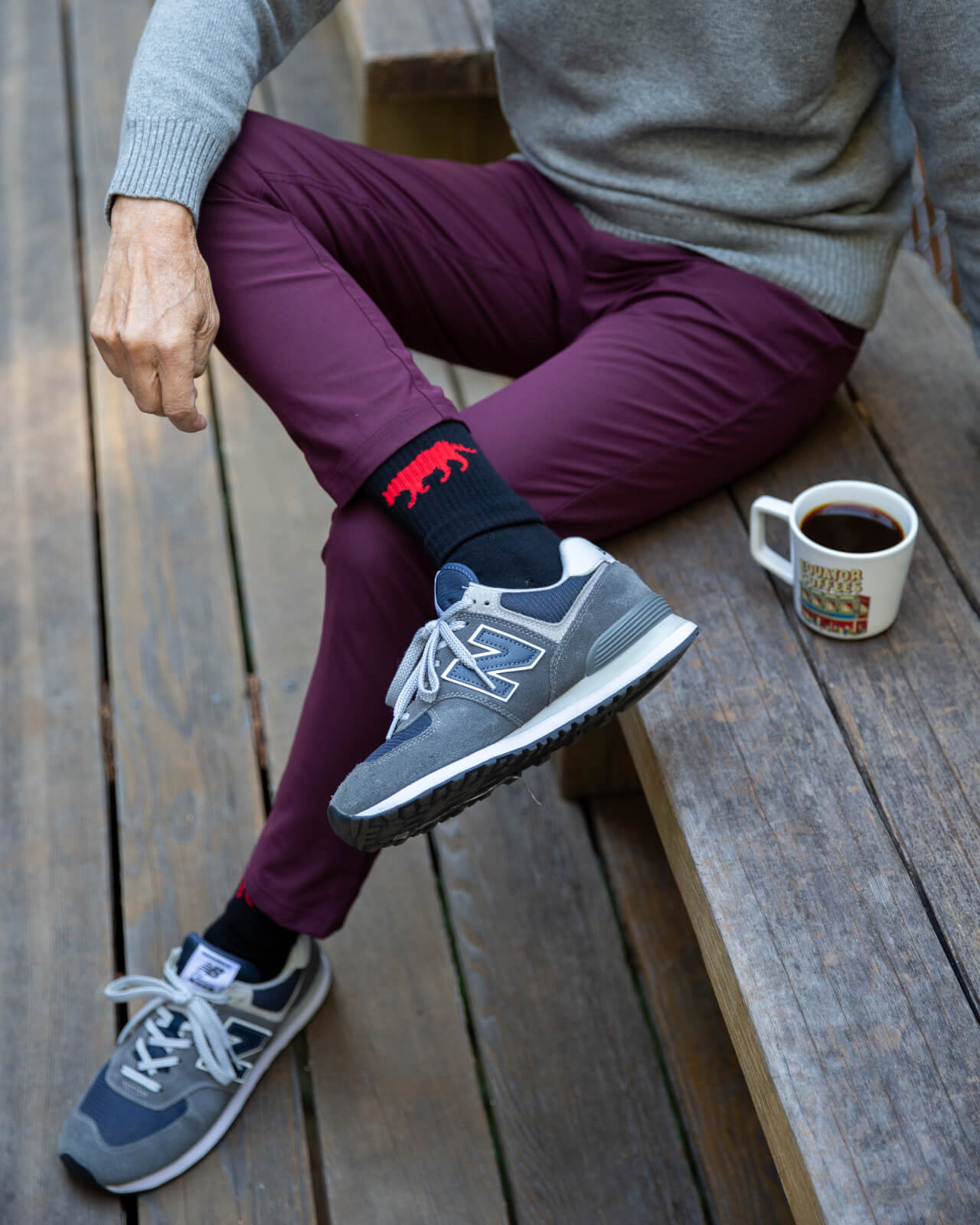 Showing off the red and black Equator performance socks outdoors with a pair of New Balance | Equator Coffees