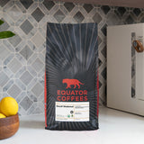 5lb bag of whole bean Decaf Shakeout coffee on a marble counter | Equator Coffees